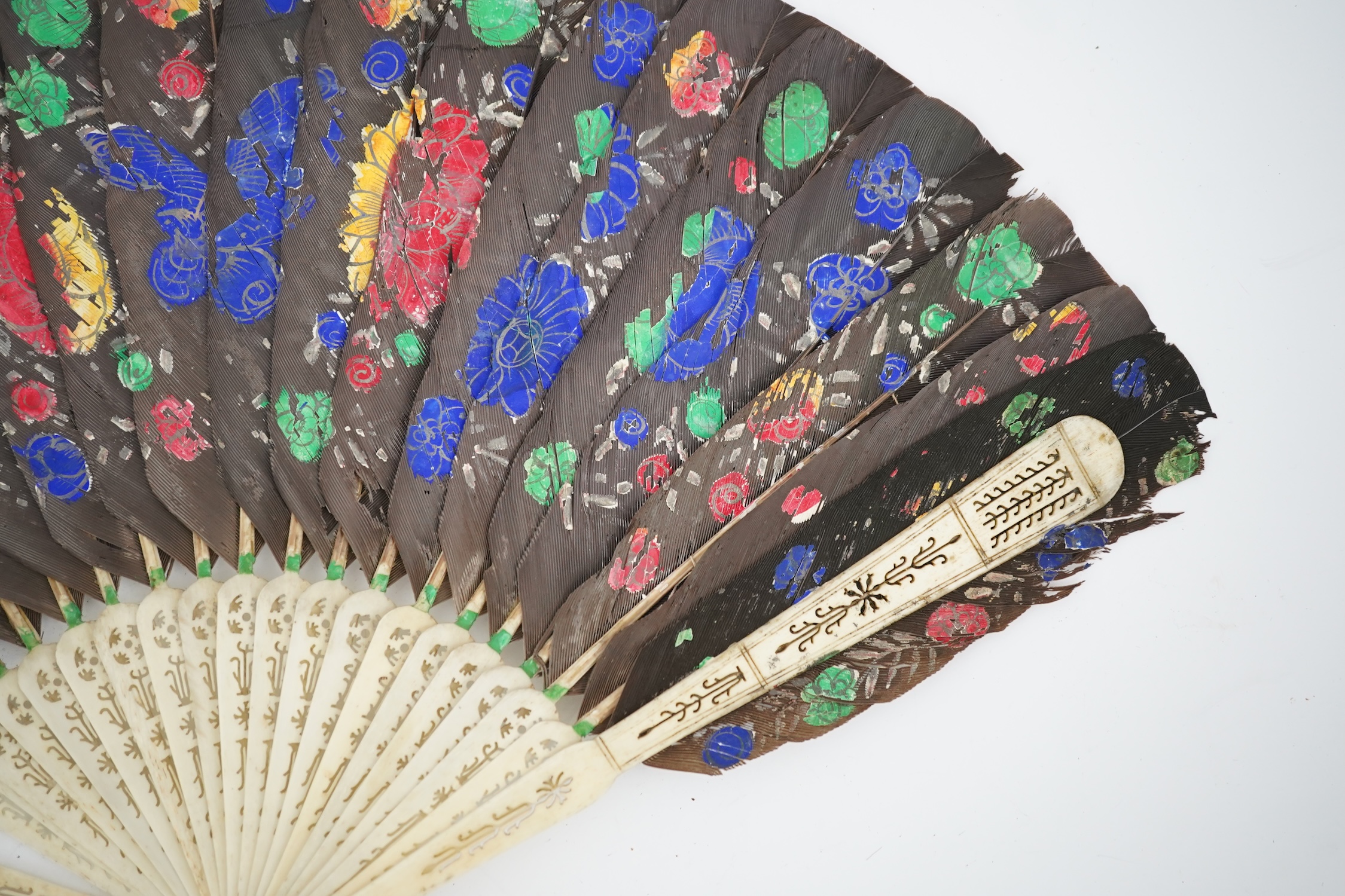 Three 19th century Chinese feather fans: One a carved bone brise black feather fan together with two similar carved sandalwood feather fans, two fans have hand painted decoration on the feathers both sides, the pink feat